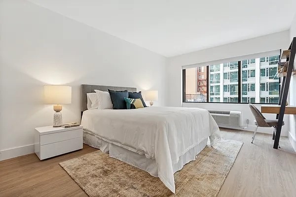 160 West 24th Street, Unit 14K Manhattan, NY 10011 - Photo 5 of 11 a bedroom with a bed and a large window