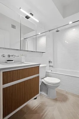 160 West 24th Street, Unit 14K Manhattan, NY 10011 - Photo 7 of 11 a bathroom with a sink a toilet and shower