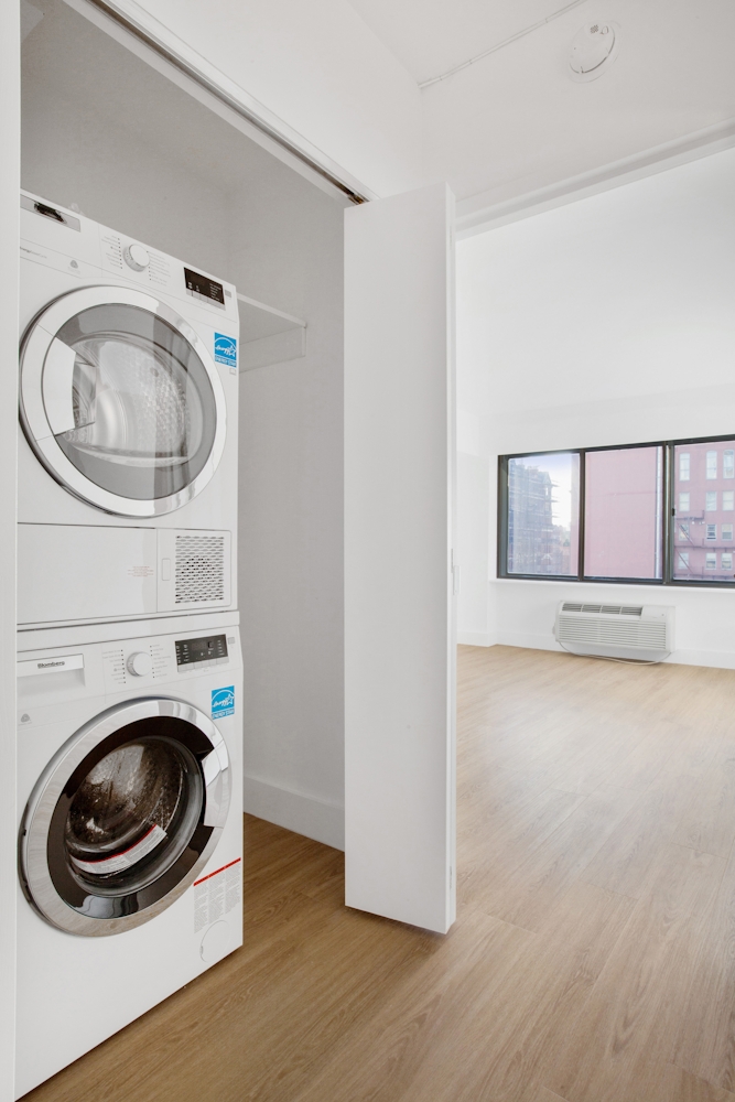 160 West 24th Street, Unit 14K Manhattan, NY 10011 - Photo 8 of 11 a view of a storage and utility room with washer and dryer