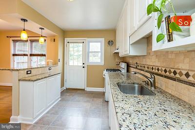 6112 Mt Ridge Road Baltimore, MD 21228 - Photo 10 of 30 a kitchen with a sink stove and microwave
