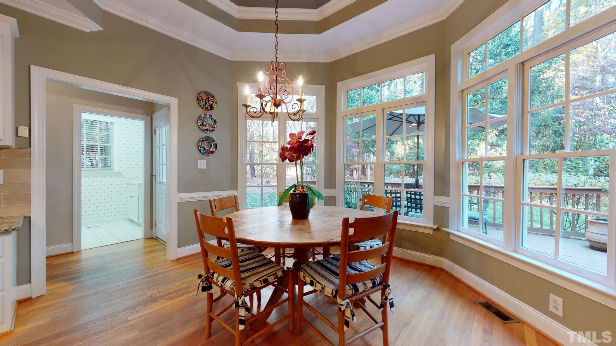 1024 White Crane Way Raleigh, NC 27615 - Photo 11 of 30 a dining room with furniture a chandelier and wooden floor