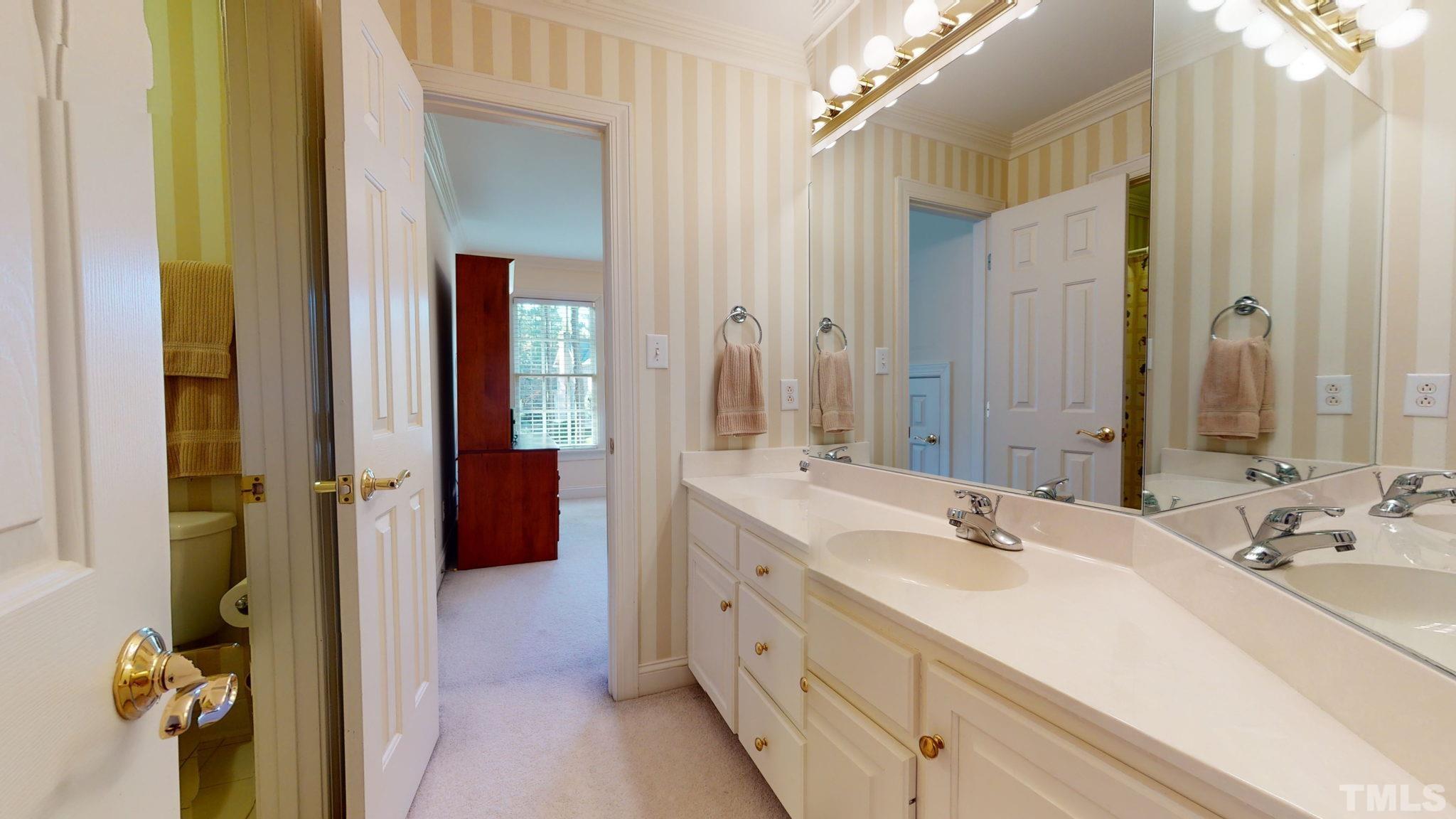 1024 White Crane Way Raleigh, NC 27615 - Photo 20 of 30 a bathroom with a double vanity sink and mirror