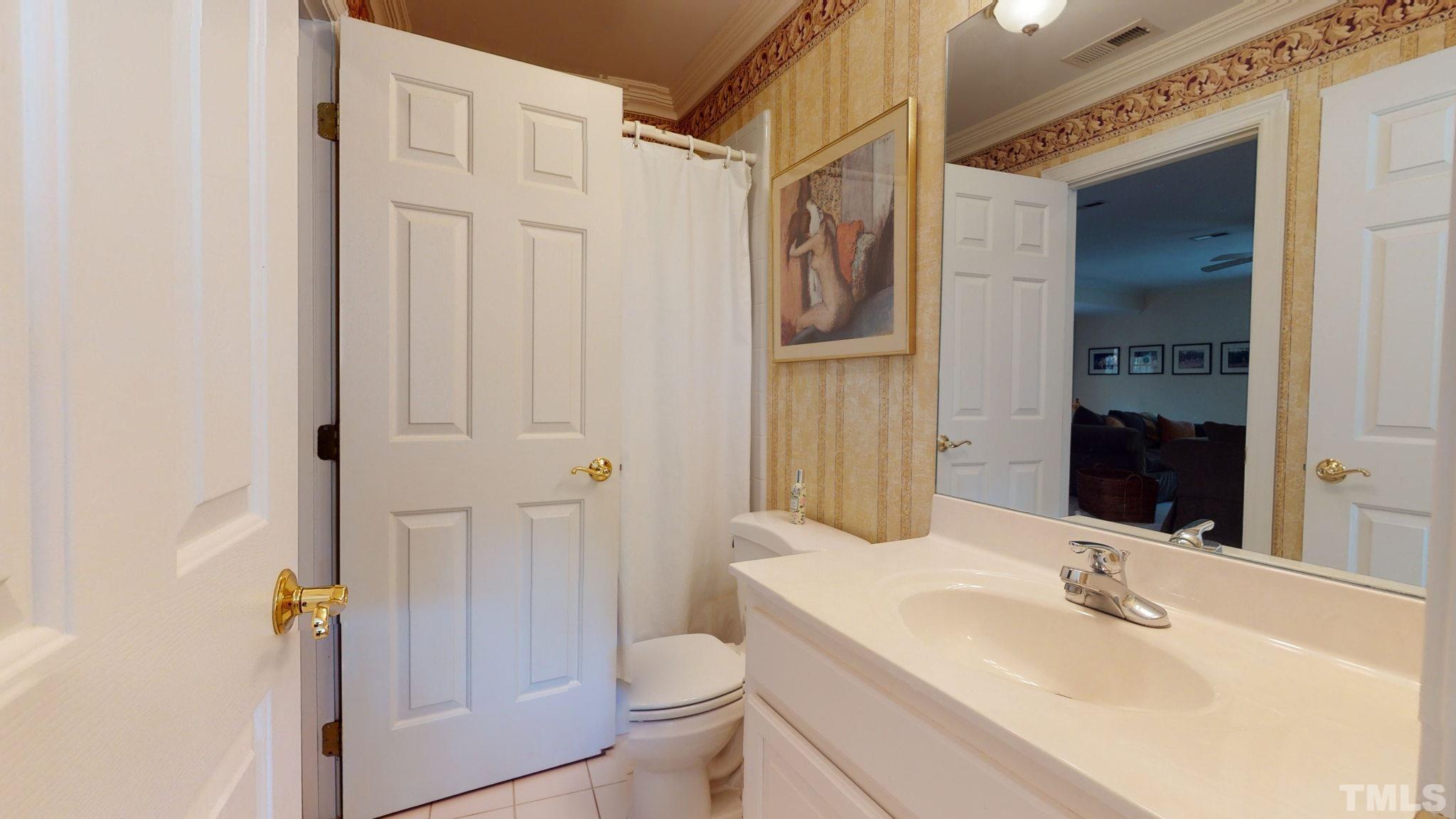 1024 White Crane Way Raleigh, NC 27615 - Photo 21 of 30 a bathroom with a sink a toilet and shower