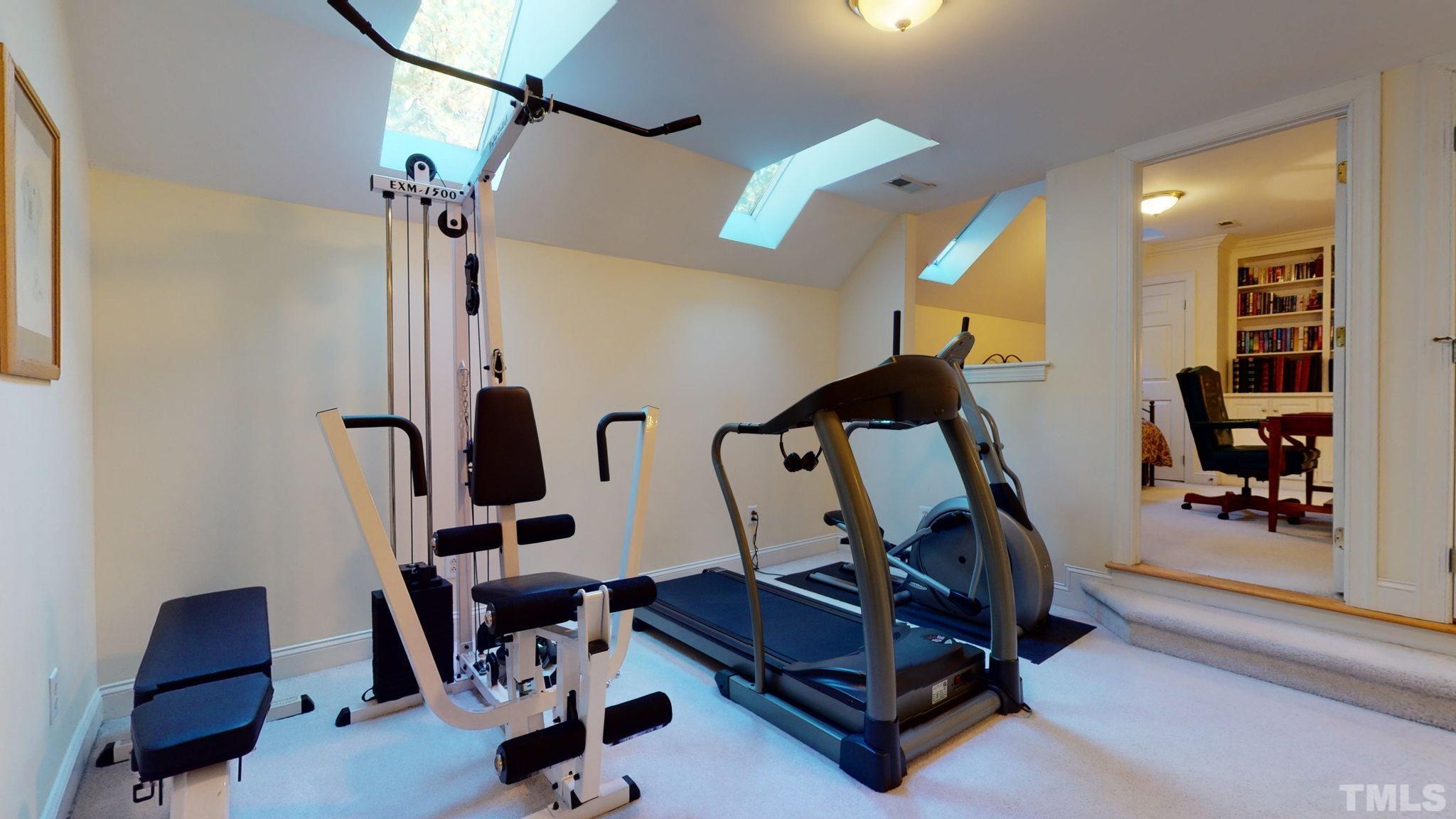 1024 White Crane Way Raleigh, NC 27615 - Photo 23 of 30 a room with gym equipment and a mirror