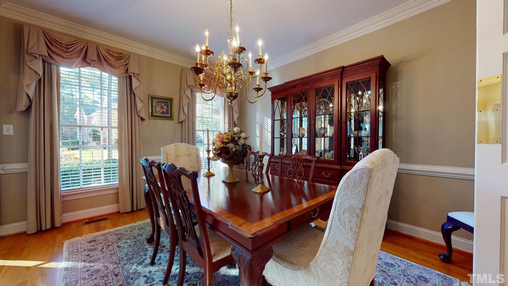 1024 White Crane Way Raleigh, NC 27615 - Photo 7 of 30 a dining room with furniture a chandelier and window