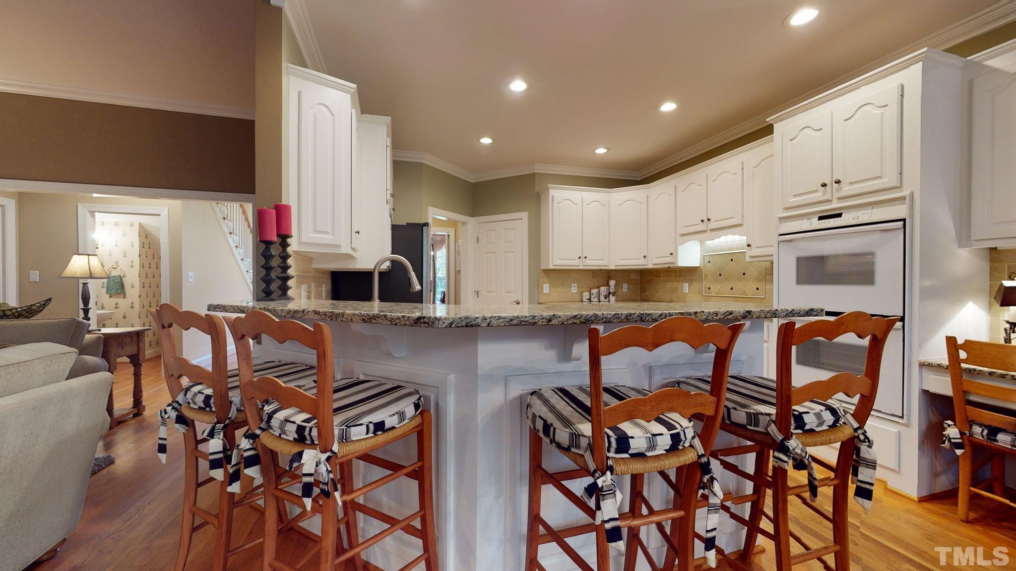 1024 White Crane Way Raleigh, NC 27615 - Photo 10 of 30 a kitchen with stainless steel appliances granite countertop a stove a sink and a refrigerator