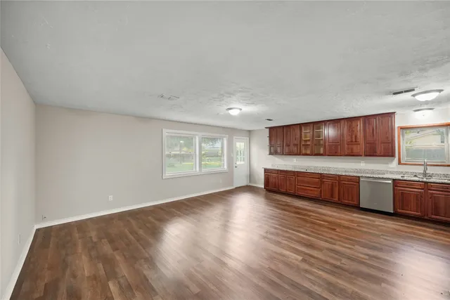 a view of room with wooden floor and windows