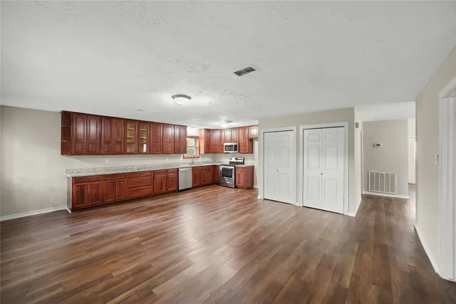 a room with wooden floors and pool table