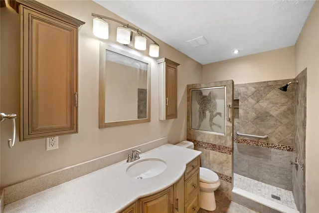 a bathroom with a sink toilet and shower