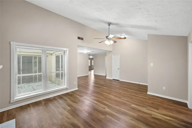 a view of a room with wooden floor and window