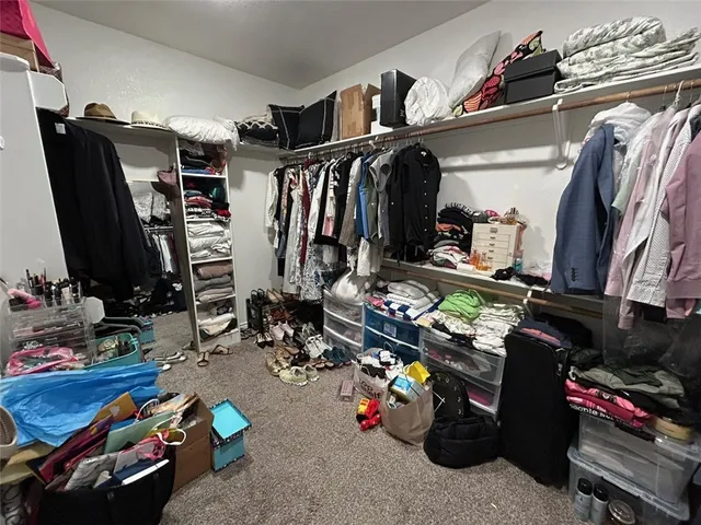 a spacious bathroom with double vanity and a mirror