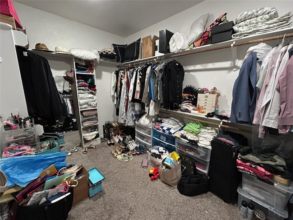 3169 Normandy Way Bryan, TX 77808 - Photo 11 of 24 a view of walk in closet with clothes and shoes