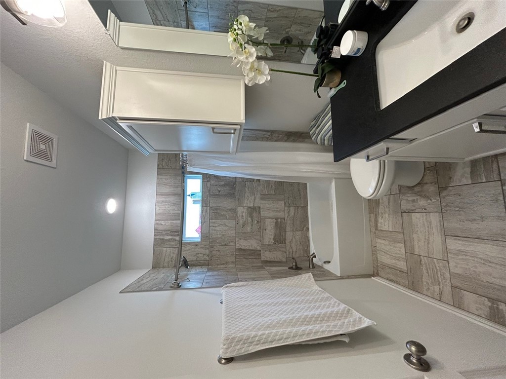 3169 Normandy Way Bryan, TX 77808 - Photo 15 of 24 a bathroom with a sink a toilet and shower