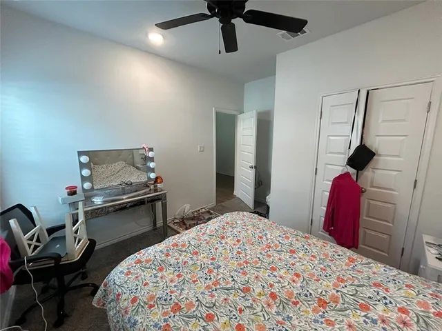 a bedroom with bed and a chandelier