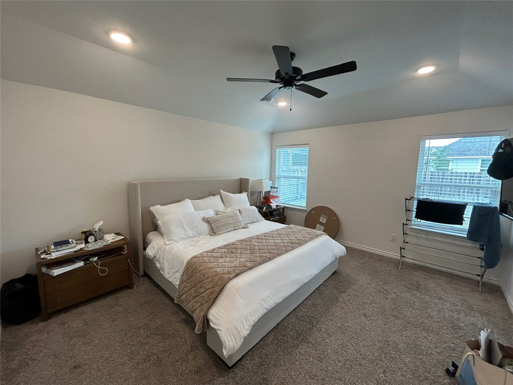 3169 Normandy Way Bryan, TX 77808 - Photo 7 of 24 a bedroom with a bed and a ceiling fan