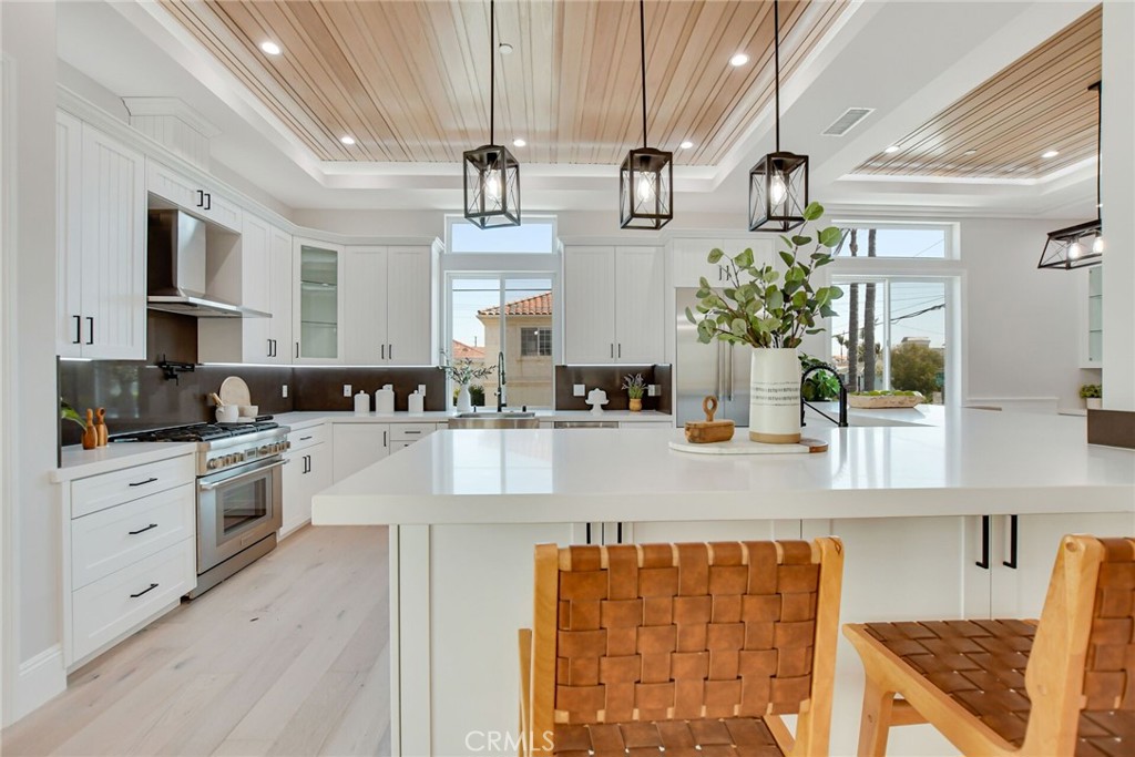 1725 Clark Lane Redondo Beach, CA 90278 - Photo 13 of 47 a large kitchen with stainless steel appliances granite countertop a lot of counter space and a sink