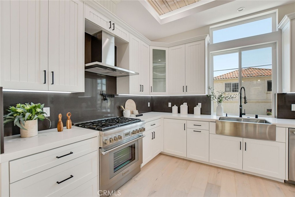1725 Clark Lane Redondo Beach, CA 90278 - Photo 14 of 47 a kitchen with cabinets a window and stainless steel appliances