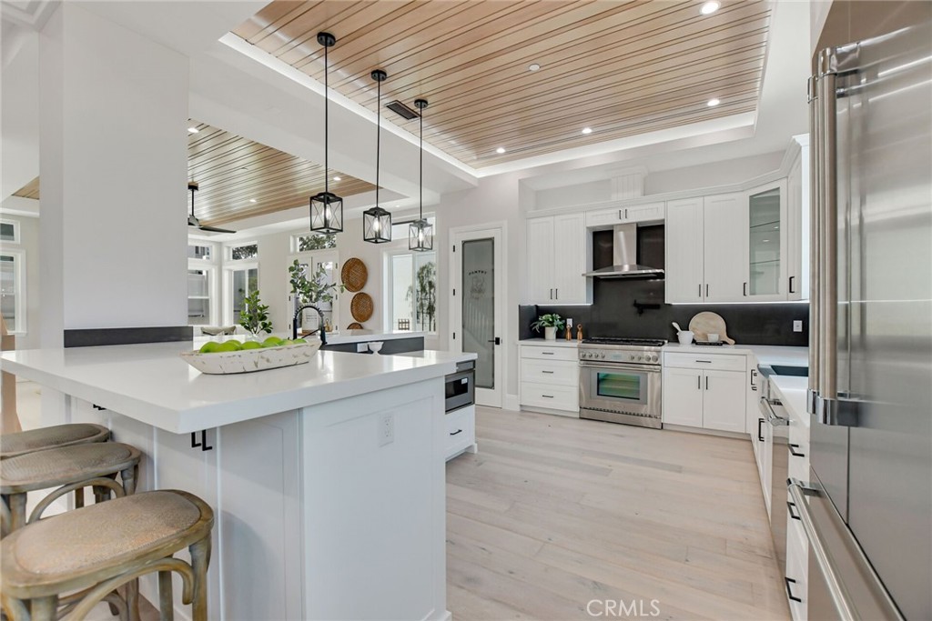 1725 Clark Lane Redondo Beach, CA 90278 - Photo 16 of 47 a kitchen with white cabinets and stainless steel appliances