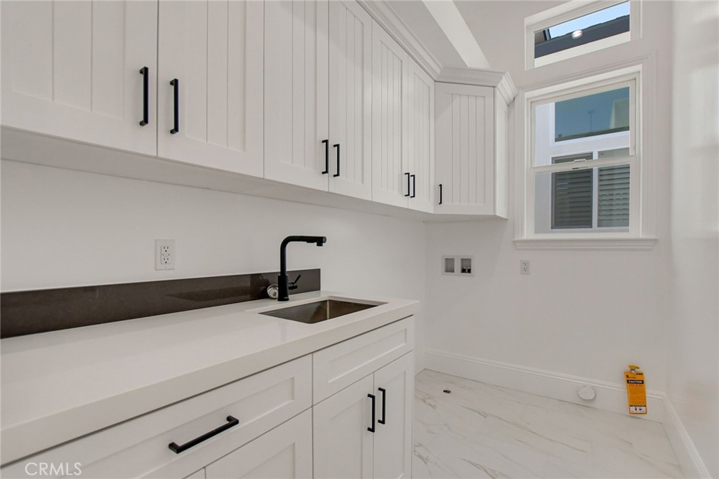 1725 Clark Lane Redondo Beach, CA 90278 - Photo 40 of 47 a kitchen with white cabinets and a sink