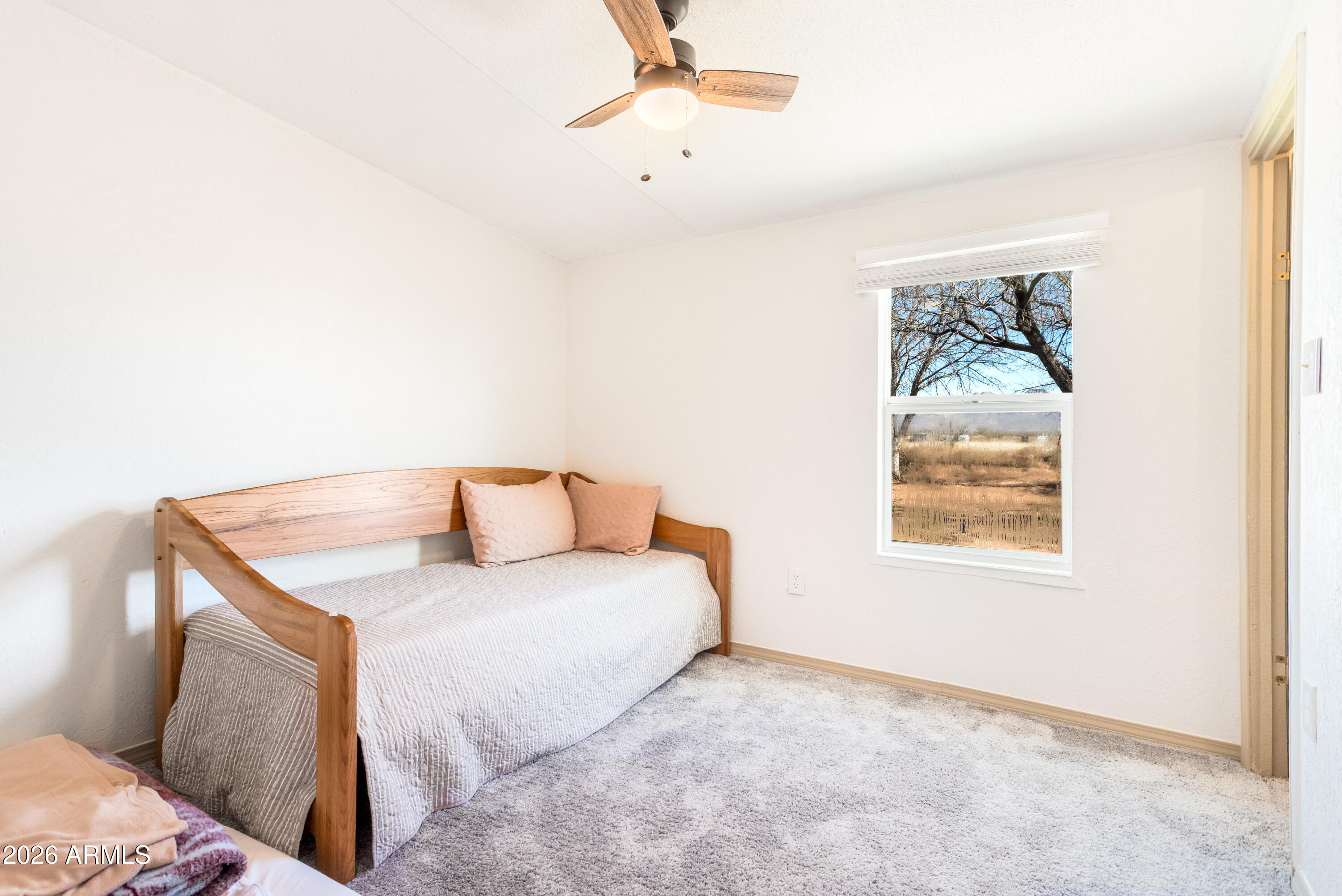 10405 North Mormon Road Elfrida, AZ 85610 - Photo 24 of 43 a bedroom with a bed and a window