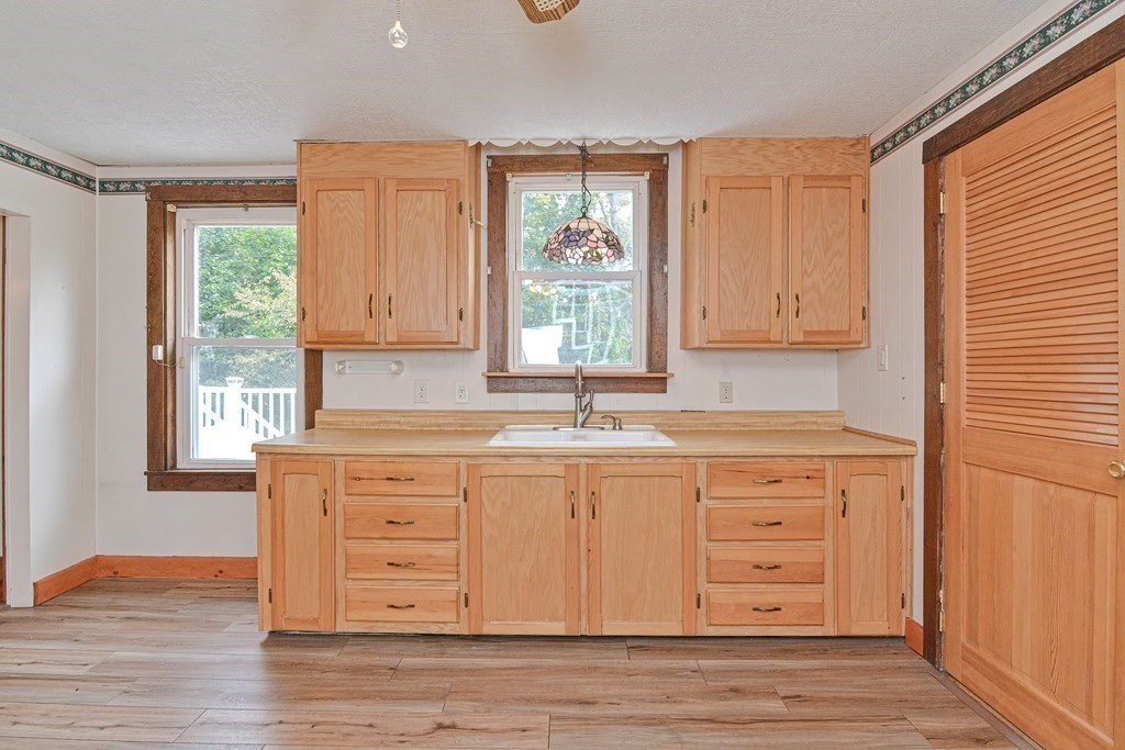 775 3rd Avenue Woonsocket, RI 02895 - Photo 13 of 42 a kitchen with granite countertop wooden cabinets and a window