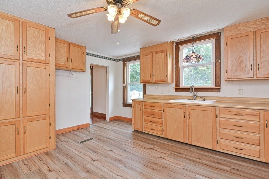 775 3rd Avenue Woonsocket, RI 02895 - Photo 15 of 42 a kitchen with granite countertop wooden floors and wide window