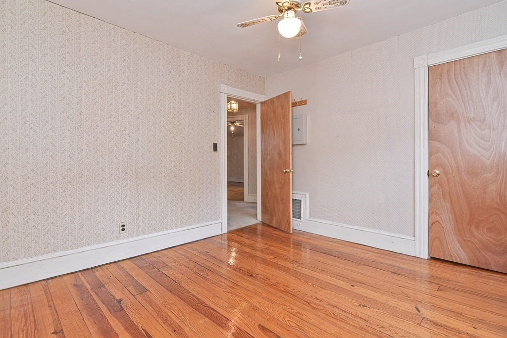 775 3rd Avenue Woonsocket, RI 02895 - Photo 29 of 42 an empty room with wooden floor and mirror
