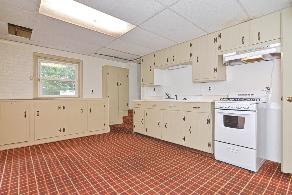 775 3rd Avenue Woonsocket, RI 02895 - Photo 32 of 42 a utility room with cabinets washer and dryer
