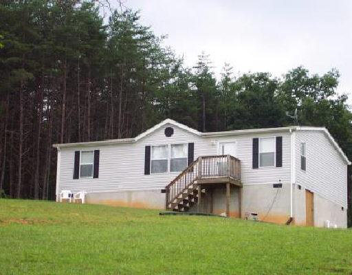 4633 Quarterwood Road Thaxton, VA 24174 - Photo 1 of 1 a front view of a house with a garden and yard