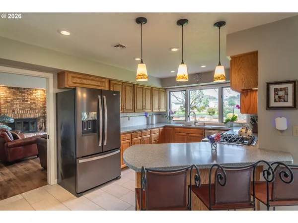 a kitchen with a table chairs and refrigerator