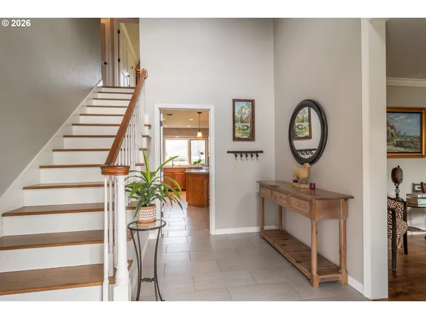 a view of entryway and hall with wooden floor