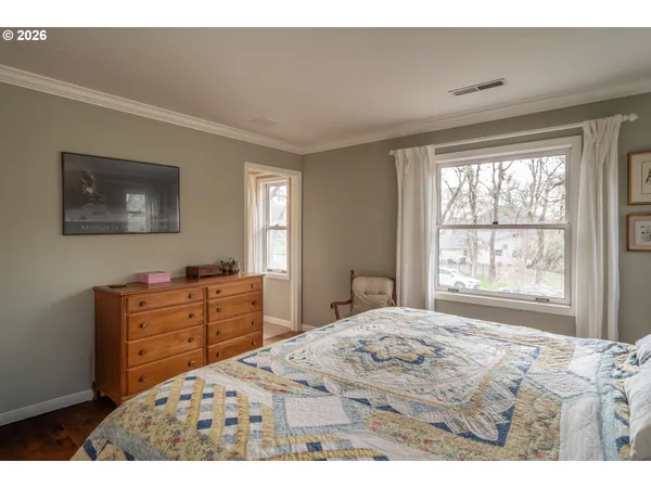 a bedroom with a bed and a window in it