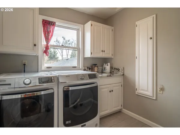 a kitchen with a sink cabinets and window