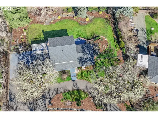 an aerial view of a house with a yard basket ball court and outdoor seating