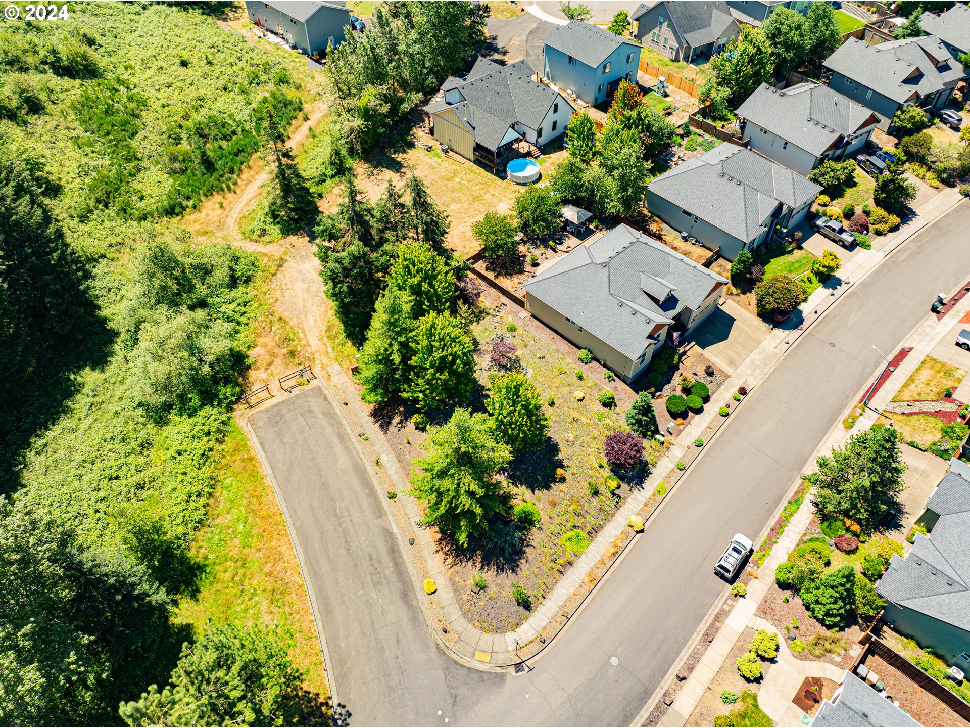 985 Pinetop Street Sweet Home, OR 97386 - Photo 4 of 6 an aerial view of a house with a garden and swimming pool