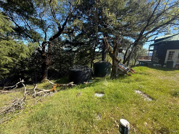 a backyard of a house with table and chairs