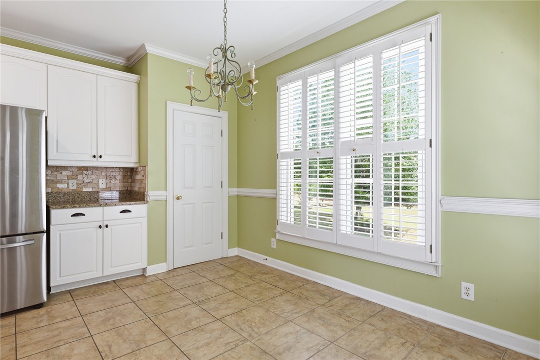 110 Garden Gate Drive Anderson, SC 29621 - Photo 17 of 35 This bright eat-in kitchen features a chandelier and stylish tile flooring.