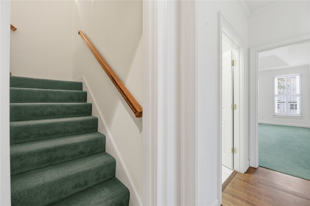 110 Garden Gate Drive Anderson, SC 29621 - Photo 28 of 35 This interior showcases a carpeted stairway leading to a bright room with hardwood flooring.