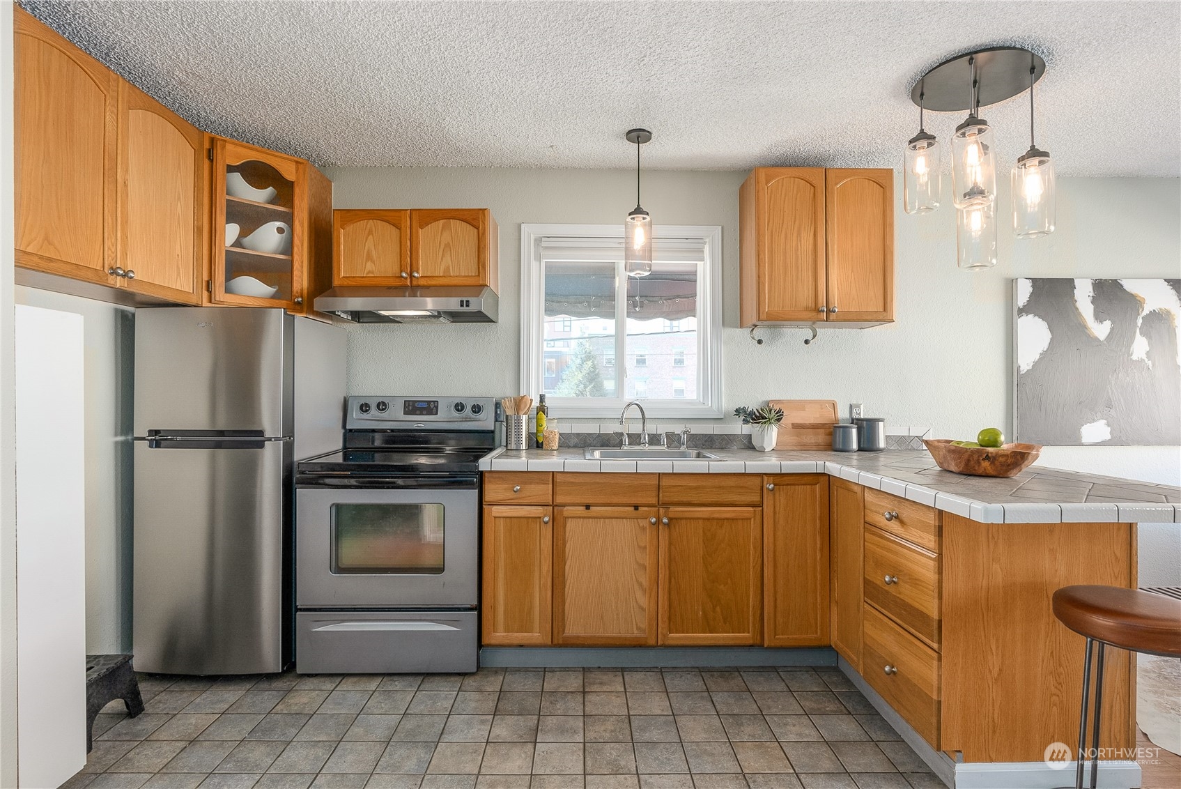 120 14th Avenue, Unit 10 Seattle, WA 98122 - Photo 12 of 21 a kitchen with stainless steel appliances granite countertop a sink a stove a refrigerator and island