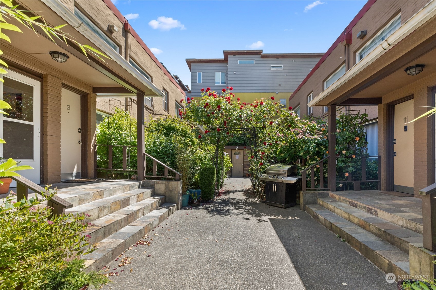 120 14th Avenue, Unit 10 Seattle, WA 98122 - Photo 3 of 21 a view of a patio with table and chairs potted plants