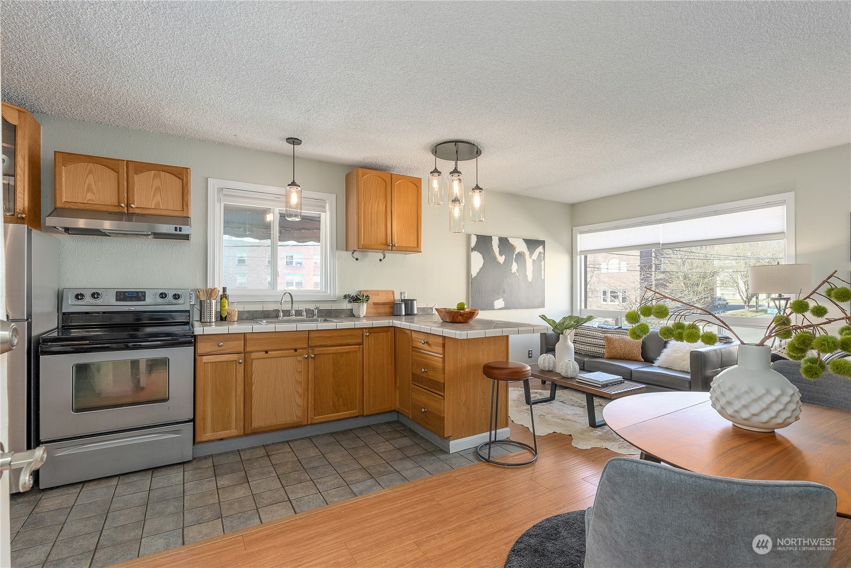 120 14th Avenue, Unit 10 Seattle, WA 98122 - Photo 7 of 21 a kitchen with sink cabinets and outdoor view