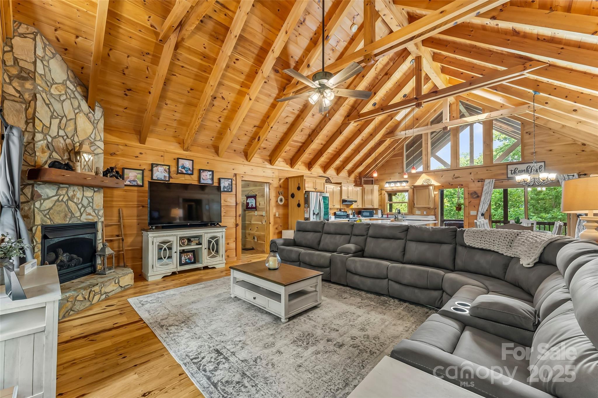 279 Outback Trail Nebo, NC 28761 - Photo 11 of 45 a living room with furniture a flat screen tv and a fireplace