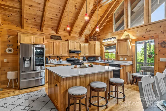 a large kitchen with a table and chairs
