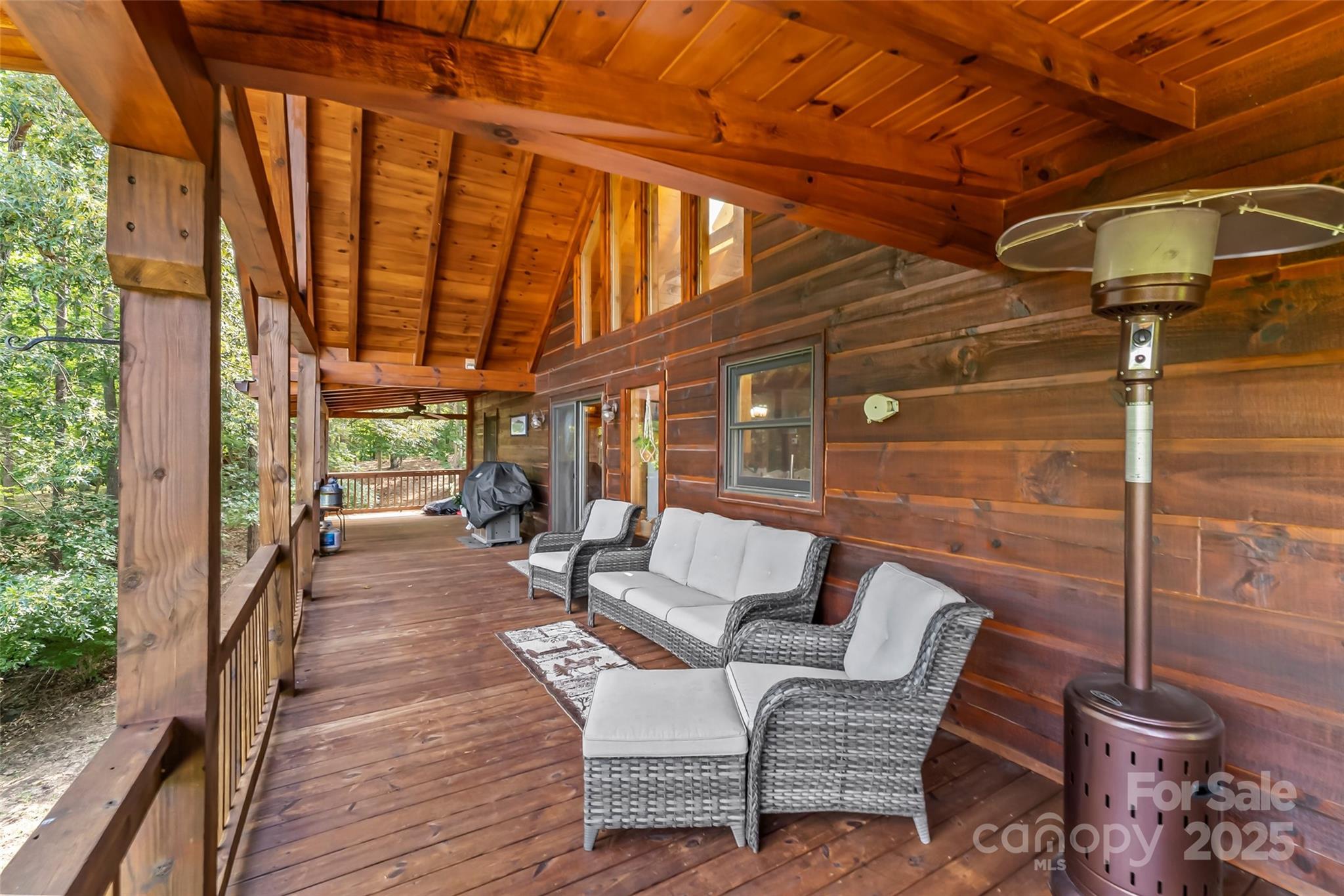 279 Outback Trail Nebo, NC 28761 - Photo 23 of 45 a view of a patio with table and chairs and wooden floor