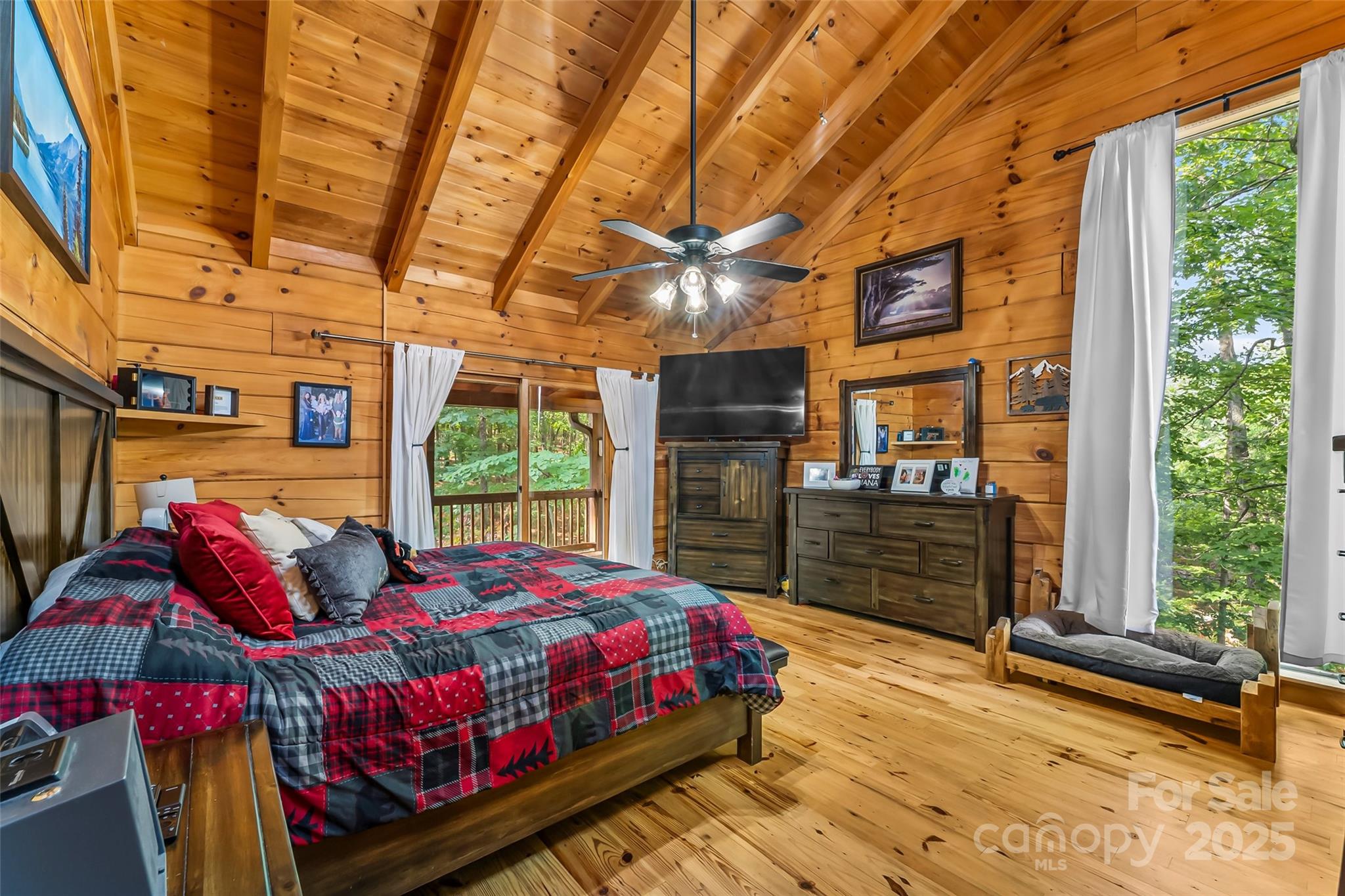 279 Outback Trail Nebo, NC 28761 - Photo 24 of 45 a bedroom with a bed and large windows