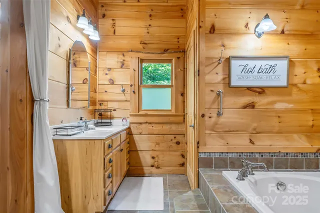 a bathroom with a tub sink and mirror