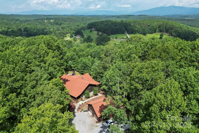 an aerial view of a house with yard and outdoor seating
