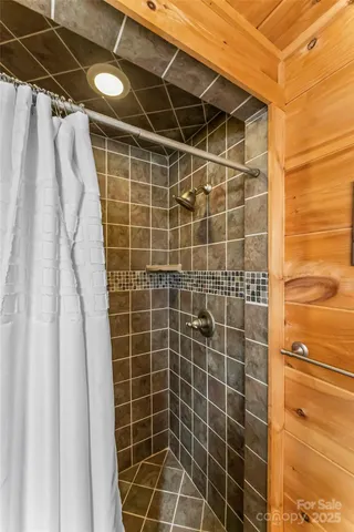 a bathroom with a shower and a glass door shower