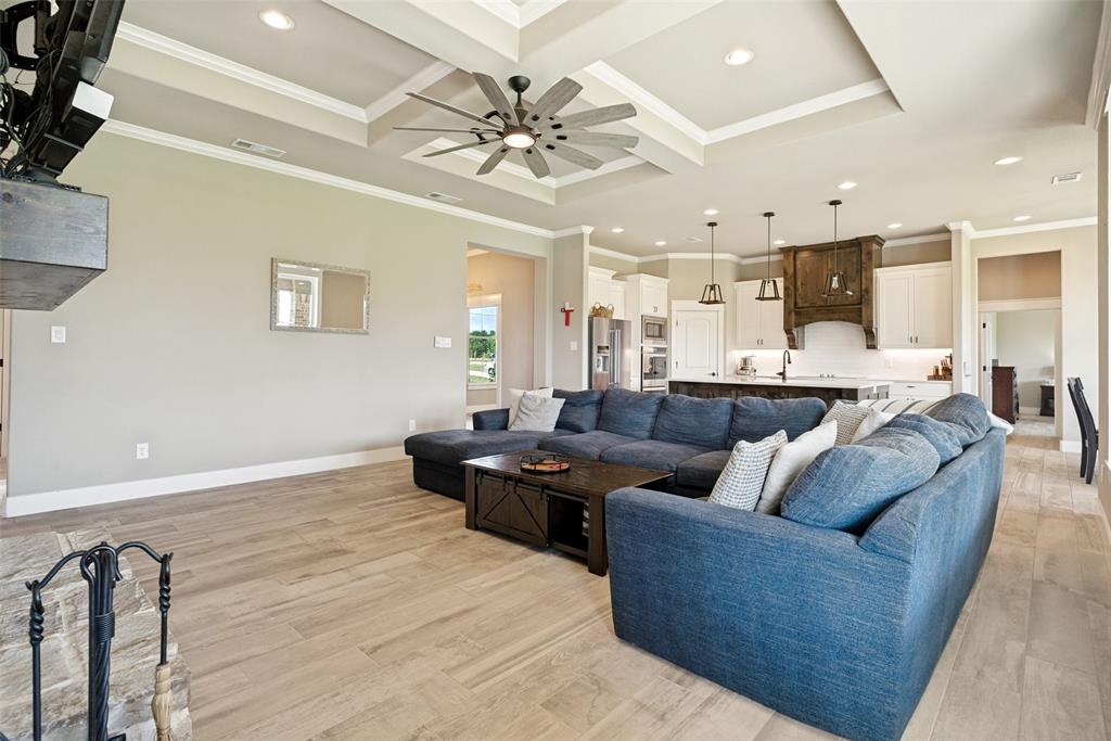 6913 Veal Station Road Weatherford, TX 76085 - Photo 6 of 31 Open-concept living area with wood-finish flooring, a tray ceiling, recessed lighting, and a contemporary ceiling fan