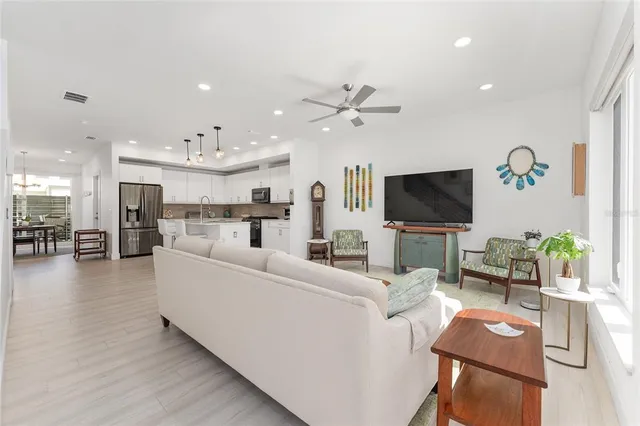 a view of a kitchen with furniture and wooden floor